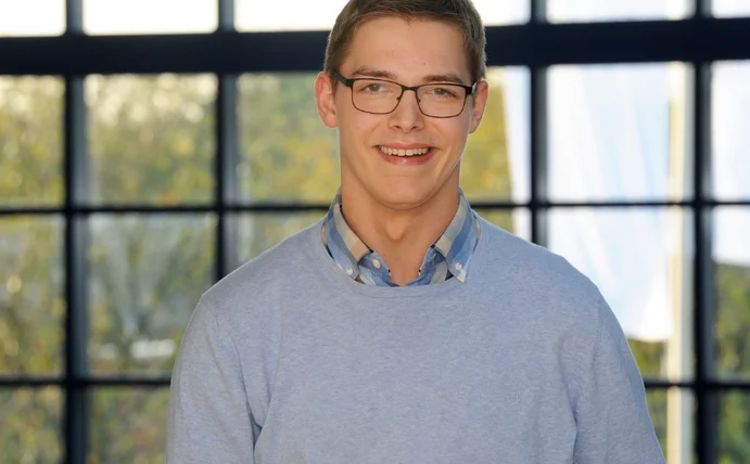 A portrait of Philipp Kofler, shown from the neck down to his chest.