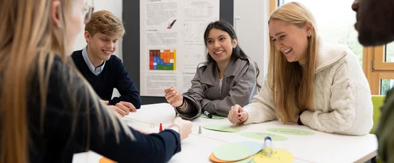 Psychology Master's students work as a group at one table