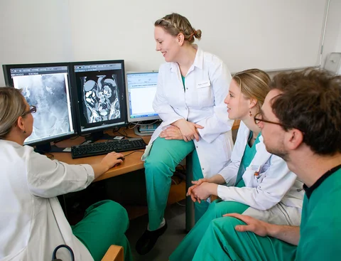Care staff are looking at a screen.