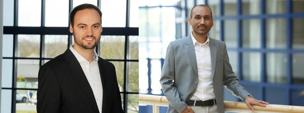 Zwei junge Männer stehen im Gebäude der Uni Witten/Herdecke