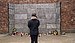 A student stands in front of a memorial at Auschwitz concentration camp