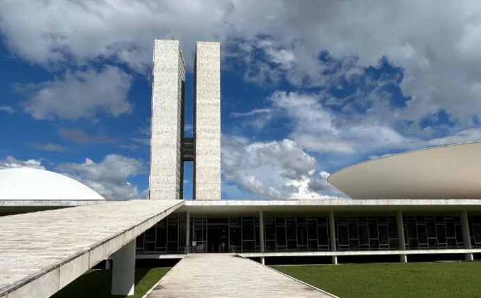 The photograph shows the Brazilian Parliament, with its distinctive twin towers and the dome on the roof