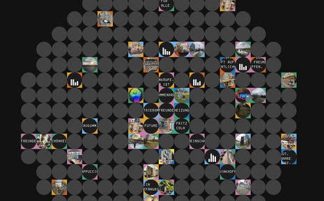 Many grey circles can be seen on a dark background. Embedded in some of the circles are small round photos and coloured icons showing places, buildings, events, nature motifs, etc. The arrangement looks like a mosaic. The arrangement looks like a mosaic.