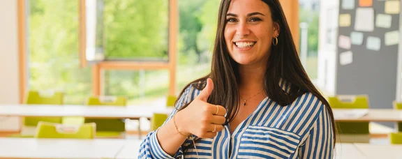 A student gives a thumbs-up.
