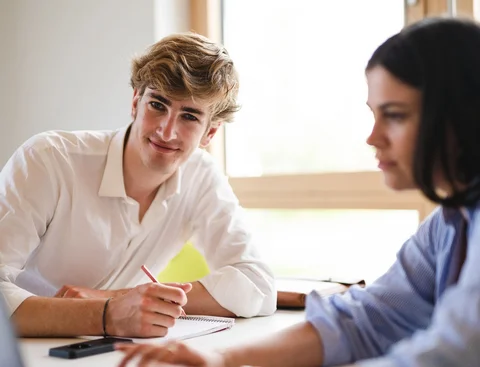 Bewirb dich für den Studiengang Wirtschaft, Politik und Recht (B. A.) an der UW/H. (Foto: UW/H | Johannes Buldmann) Ein junger Mann und eine junge Frau sitzen mit einem Laptop an einem Tisch.