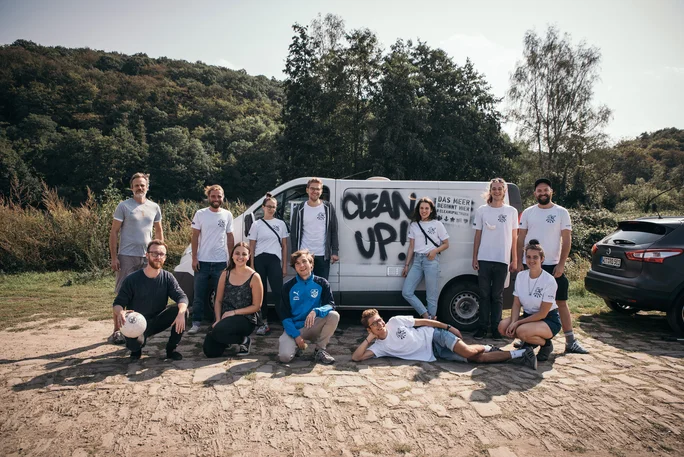 UW/H students are involved in RuhrCleanUp. (Photo: Chris Lührmann) Committed students pose in front of a white van labelled "Clean Up".