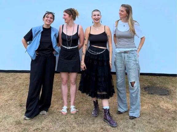 It is important to Ia to get involved at the UW/H. In the summer term of 2025, she organised an open-air cinema evening together with fellow students. (Photo: private) Four female students are standing together in front of a white screen, smiling at the camera.