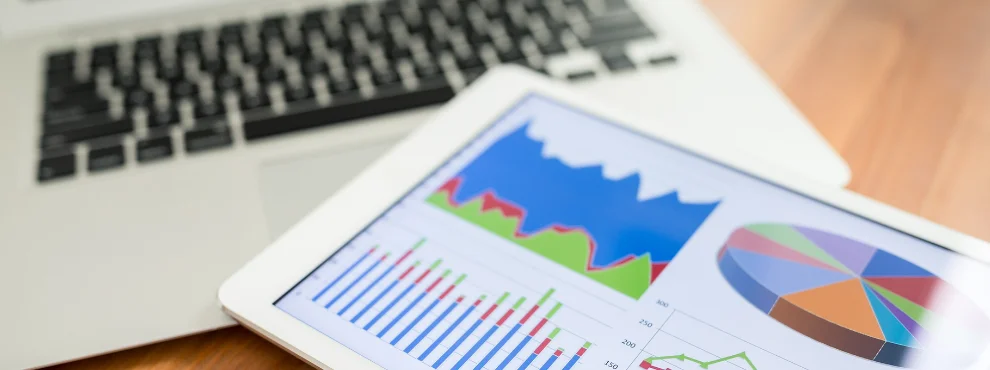 Verschiedene ausgedruckte Diagramme liegen auf einem Laptop. Symbolbild für die durchgeführte Studie.