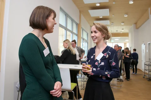 Two scholarship holders and other participants at the ceremony for Germany Scholarship holders