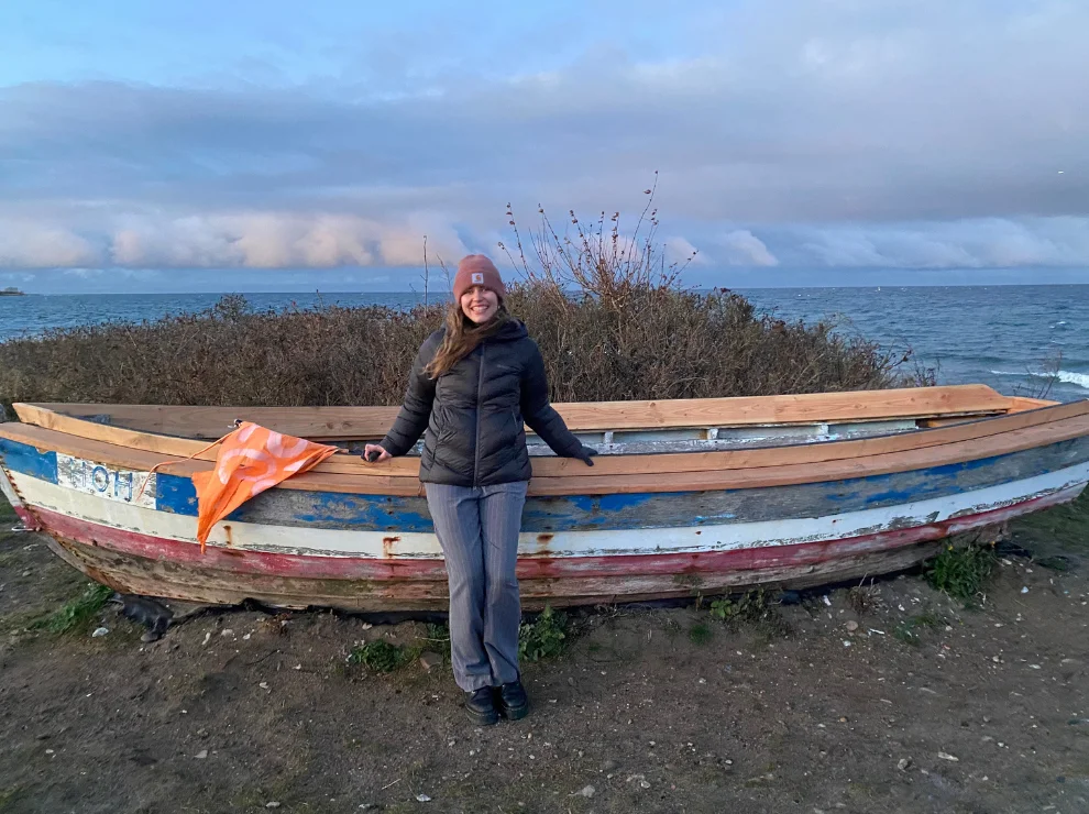 Carlotta Fehrmann stands in front of a wooden barge