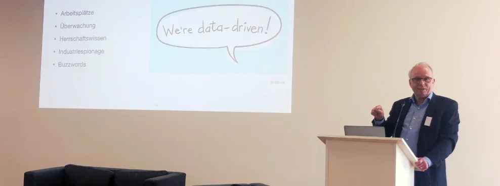 A man stands at a lectern and gives a presentation.