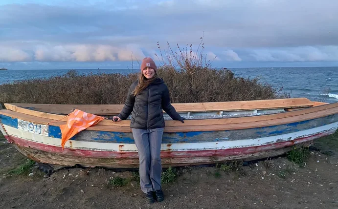 Carlotta Fehrmann stands in front of a wooden barge