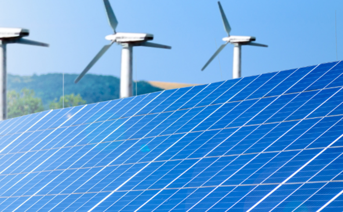 Financial policy can accelerate the green transformation (Photo: Canva) Solapanels can be seen in the foreground and three wind turbines in the background.