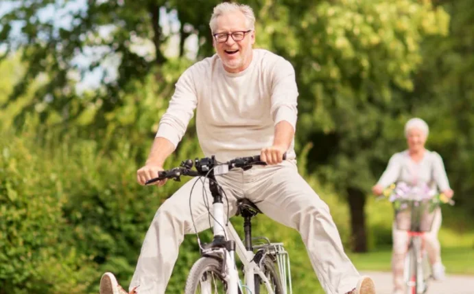 Ein Mann fährt auf einem Fahrrad und streckt die Beine aus.
