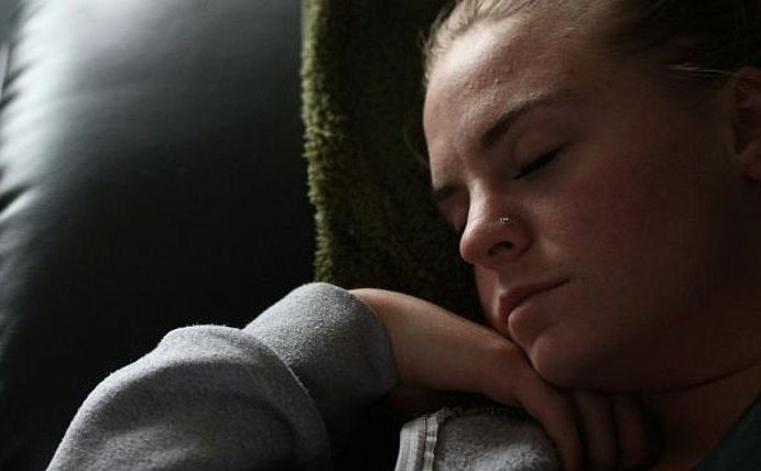 Nahaufnahme einer Frau, die in einem Sessel schläft.