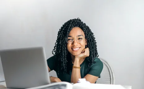 Our online taster seminars give prospective students an insight into studying psychology at UW/H. (Photo: pexels | Andrea Piacquadio) A young woman sits in front of a laptop and smiles at the camera.