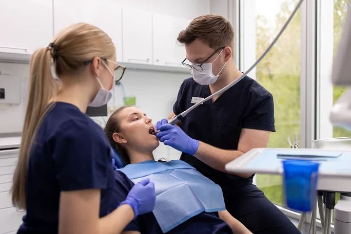 Dental students performing a treatment exercise 