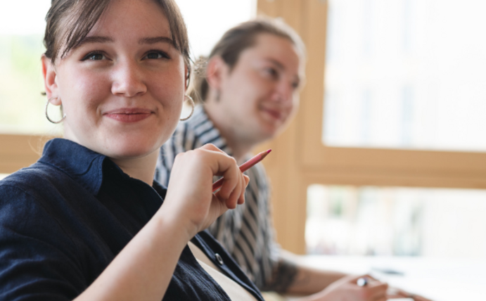 Eine Studentin lächelt in die Kamera.