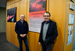 Photo artist Philip Pearce and Prof Dr Stefan Zimmer stand in front of the exhibition cover.