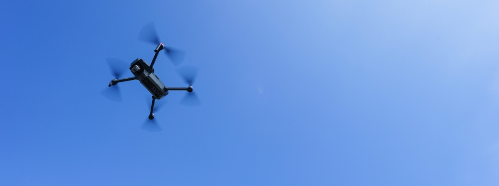 You can see a drone in the blue sky. 